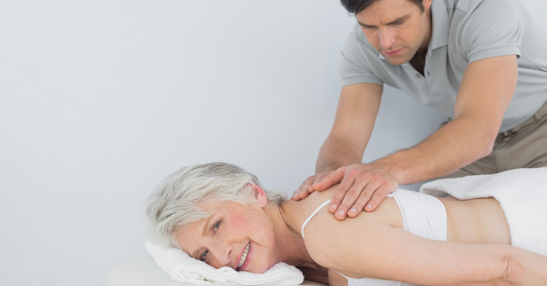 experts-main-area-bg-mobile A chiropractor performing a chiropractic adjustment to the upper back of an elderly female patient.